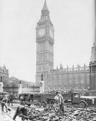 Black and white vintage photo showing VolkerFitzpatrick team doing road works outside Big Ben and Parliament in London around the 1940s.